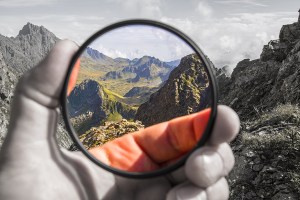 Hand puts a transparent clean protective UV filter to the camera