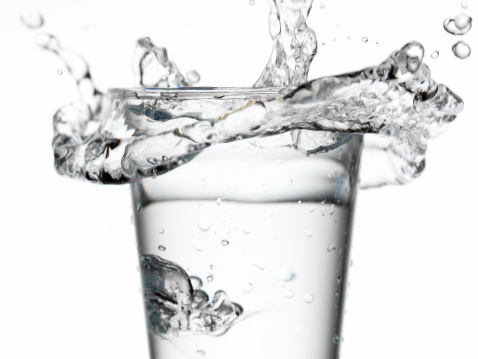 Water splashing from glass, close-up